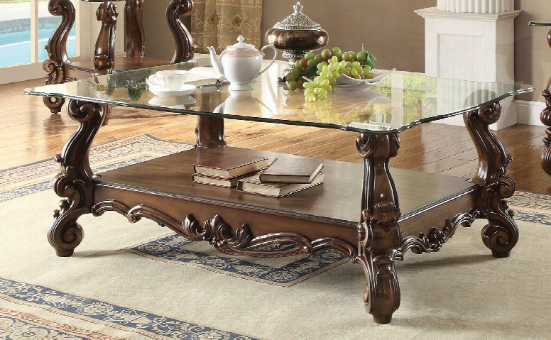 Versailles Collection 82100 56" Rectangular Coffee Table With 1-mm Tempered Clear Glass Top Beveled Edges Scroll Legs And Bottom Shelf In Cherry Oak